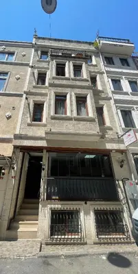 a large building with a balcony in front of it at Asteria House in Istanbul