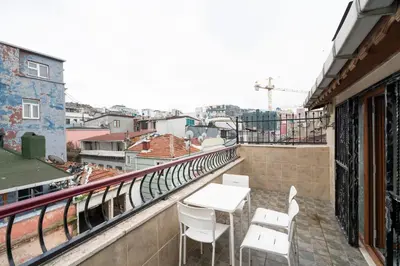 a balcony with a table and chairs on a building at Asteria House in Istanbul
