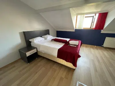 a bedroom with a bed with a red blanket at Asteria House in Istanbul