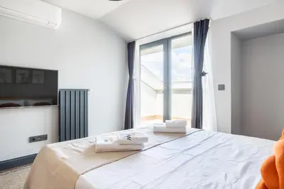 a bedroom with a bed and a large window at Benesta Residence by NewInn in Istanbul