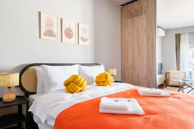 a bedroom with a bed with yellow pillows on it at Benesta Residence by NewInn in Istanbul