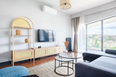 a living room with a couch and a tv at Benesta Residence by NewInn in Istanbul