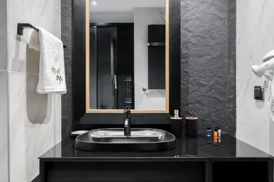 a bathroom with a sink and a mirror at Benesta Residence by NewInn in Istanbul