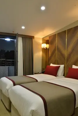 two beds in a hotel room with a window at Celine Hotel Taxim in Istanbul