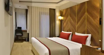 a hotel room with a large bed with red pillows at Celine Hotel Taxim in Istanbul