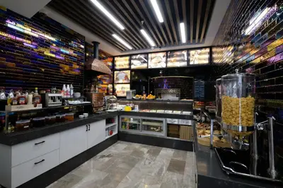 a large kitchen with a counter with food at Celine Hotel Taxim in Istanbul