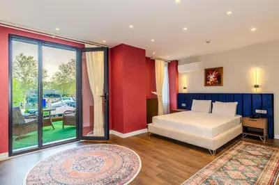 a bedroom with a bed and a large window at Istanbul Old City Topkapi Porta Romanos Hotel Ottoman Heritage in Istanbul