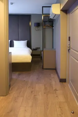 a bedroom with a bed and a wooden floor at Dilens Bosphorus Hotel in Istanbul