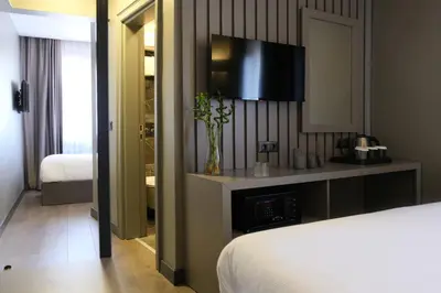 a bedroom with a bed and a television on a wall at Dilens Bosphorus Hotel in Istanbul