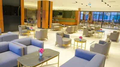 a lobby with couches and tables and chairs at SERENİTY COMFORT Hotel in Istanbul