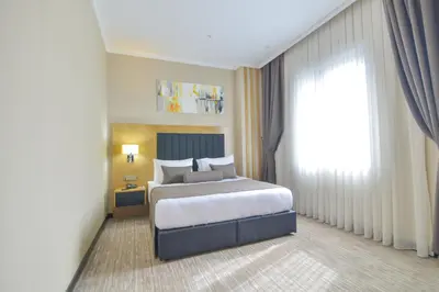 a bedroom with a bed and a large window at SERENİTY COMFORT Hotel in Istanbul