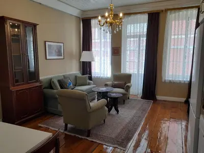 a living room with a couch and chairs and a chandelier at Agus Flats Galata in Istanbul