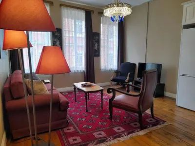 a living room with chairs and a table and two lamps at Agus Flats Galata in Istanbul