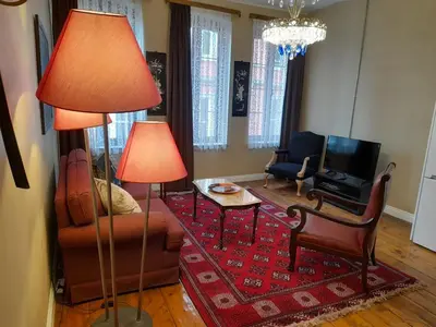a living room with two lamps and a table and chairs at Agus Flats Galata in Istanbul