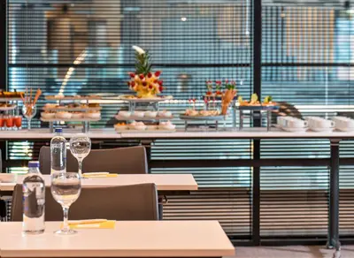 a restaurant with tables with wine glasses on them at Crowne Plaza Istanbul Tuzla Viaport Marina by IHG in Istanbul