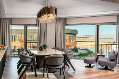 a dining room with a table and chairs and a large window at Crowne Plaza Istanbul Tuzla Viaport Marina by IHG in Istanbul