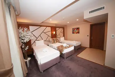 a living room with two beds and a couch at Litros Hotel & Spa in Istanbul