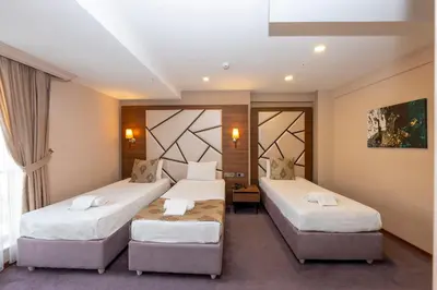 a hotel room with two beds and a window at Litros Hotel & Spa in Istanbul