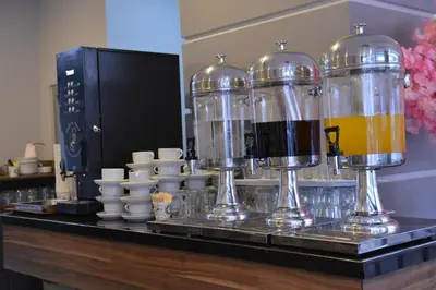 a counter with three wine bottles and cups on it at Litros Hotel & Spa in Istanbul