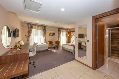 a hotel room with a bedroom and a living room at Litros Hotel & Spa in Istanbul