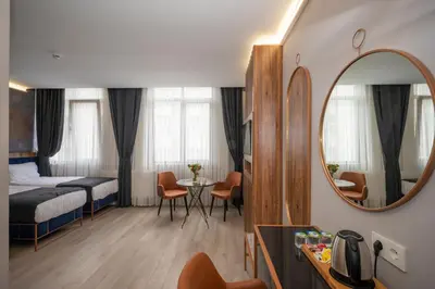 a hotel room with a bed and a mirror at Seyithan Palace Spa Hotel in Istanbul