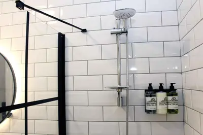 a shower in a bathroom with white tiles at Seyithan Palace Spa Hotel in Istanbul