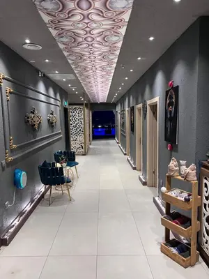 a long hallway with a ceiling with a ceiling painting at Seyithan Palace Spa Hotel in Istanbul