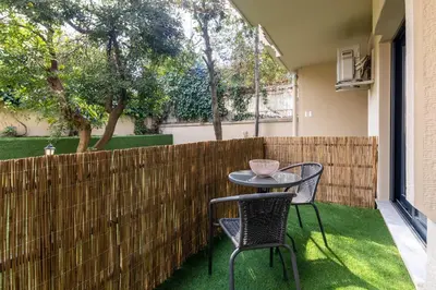 a patio with two chairs and a table and a fence at BayMari Suites Plus Florya in Istanbul