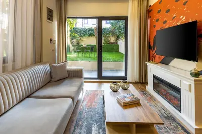 a living room with a couch and a fireplace at BayMari Suites Plus Florya in Istanbul