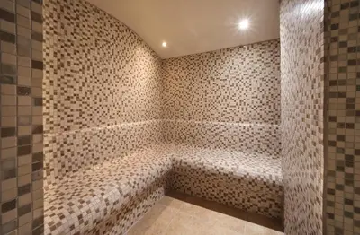 a bathroom with a bath tub with tiled walls at Stargate Hotel&Spa in Korfez