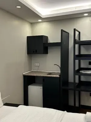 a kitchen with a sink and a desk in a room at Galata King Suites in Istanbul