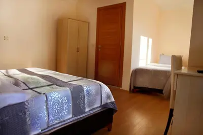 a bedroom with a bed and a window and a door at Miletus Otel Şile in Sile