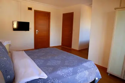 a bedroom with a bed and a flat screen tv at Miletus Otel Şile in Sile