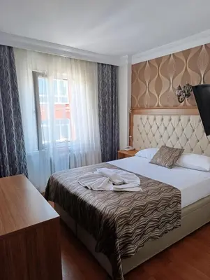 a hotel room with a bed and a window at Şirin Hotel in Istanbul