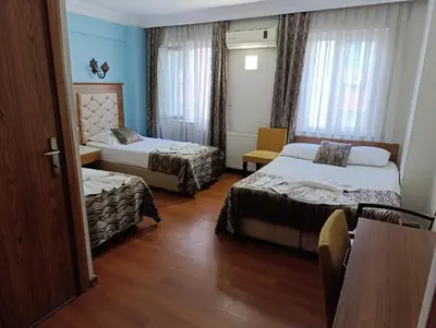 a hotel room with two beds and a window at Şirin Hotel in Istanbul