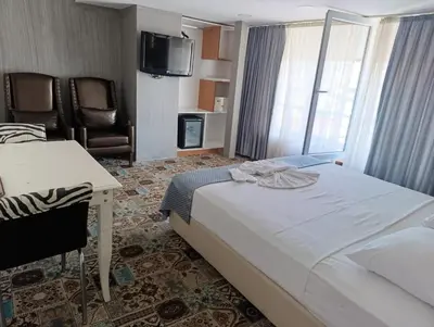 a hotel room with a bed and a desk and chair at Şirin Hotel in Istanbul
