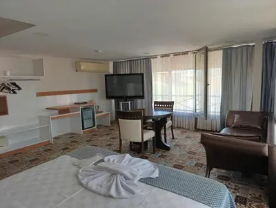 a hotel room with a bed and a living room at Şirin Hotel in Istanbul