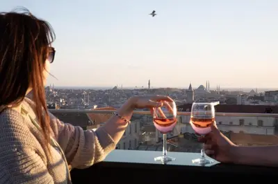 two women holding wine glasses on a ledge at The Trinity Hotel Taksim - Special Category in Istanbul