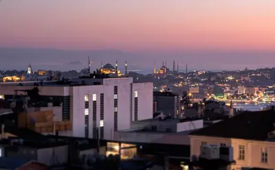 a city skyline at night with a white building at The Trinity Hotel Taksim - Special Category in Istanbul