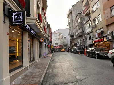 an empty city street with parked cars and buildings at KA Hotel & Suites in Istanbul