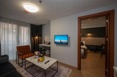 a living room with a couch and a television on a wall at KA Hotel & Suites in Istanbul