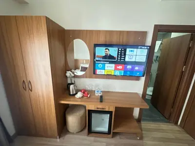 a room with a desk and a tv on a wall at Hotel La SERA in Istanbul