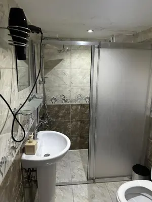 a bathroom with a shower and a sink and a toilet at yakut old hotel in Istanbul