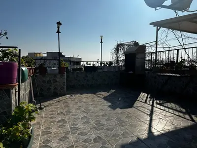 a patio with a fence and some plants at yakut old hotel in Istanbul