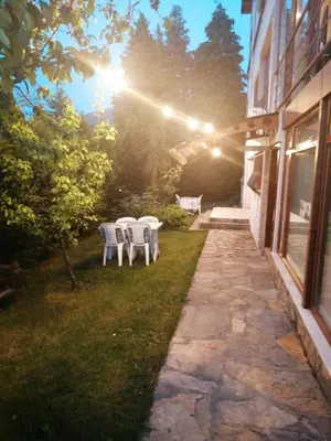 a patio with two chairs and a table in a yard at SNOW HİLL HOUSE Pansiyon in Kartepe