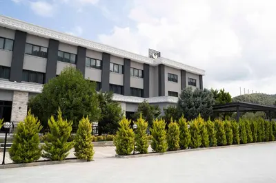 an office building with trees in front of it at Vela Verde Hotel & SPA in Yalova