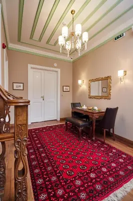 a living room with a table and a red rug at White Palace Old City Boutique Hotel in Istanbul