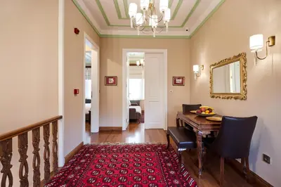 a dining room with a table and a red rug at White Palace Old City Boutique Hotel in Istanbul