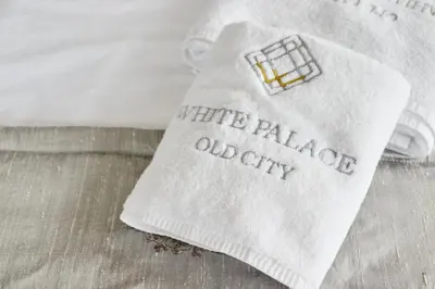 a white napkin with the words white palace and city on it at White Palace Old City Boutique Hotel in Istanbul