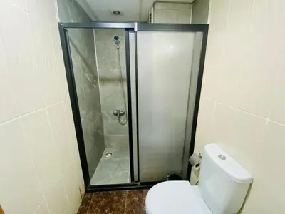 a bathroom with a shower and a white toilet at Airport Best Hotel in Istanbul